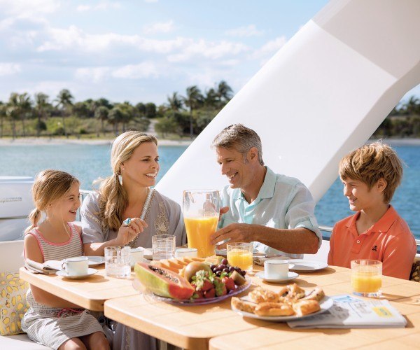 Familj som njuter av frukost tillsammans på en lyxig yachtcharter